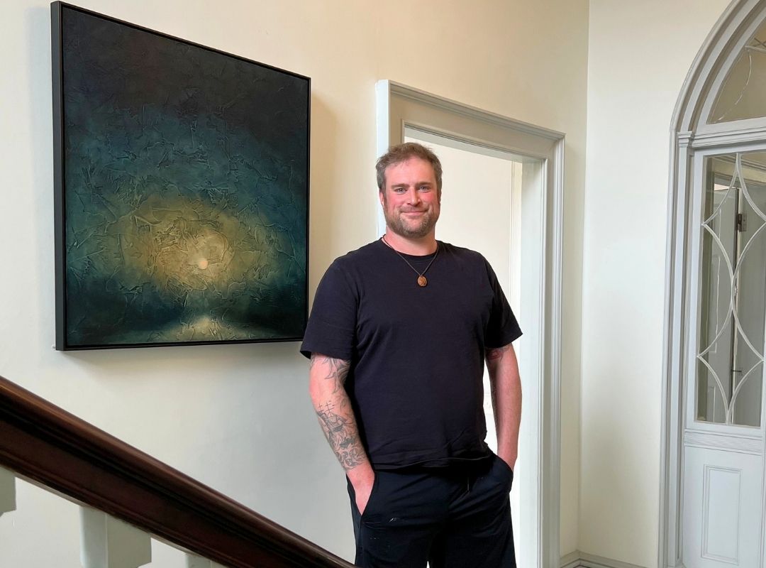 Martin Baister Artist Martin Baister stood beside an artwork
